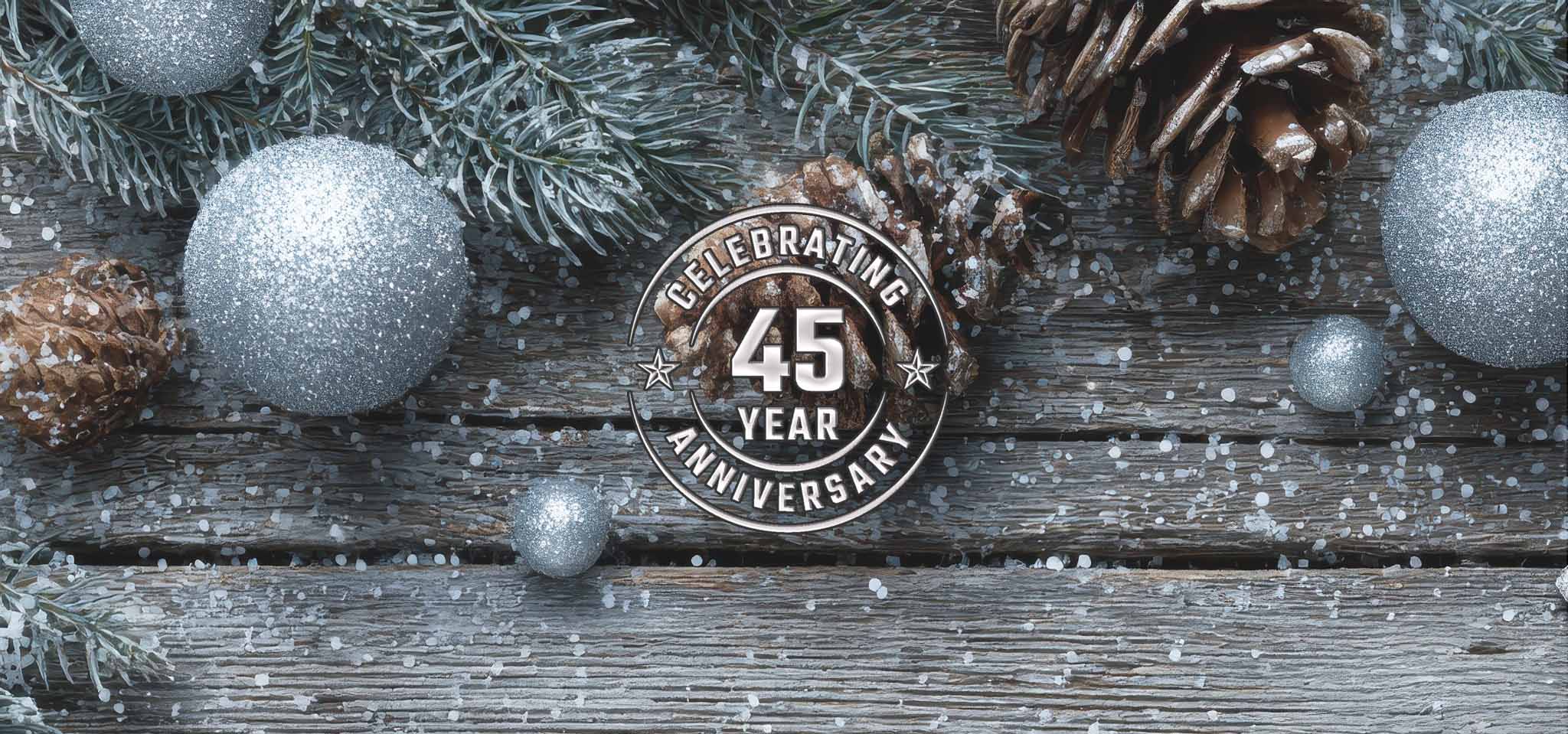 A close up of christmas balls and a 45 year seal that reads 45 years of Christmas memories