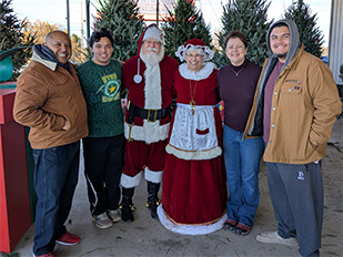 Children posing with Santa and Mrs. Claus to mark another year of love and memories at the Kiser Christmas Tree Market